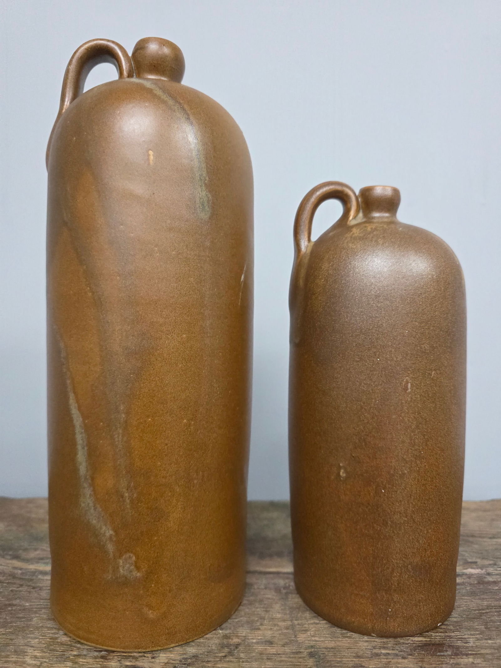W J Gordy Single-Handle Jugs Lot of 2: W J Gordy Jugs Lot of 2. Both are Mountain Gold glaze, both are single-handle and are signed on the bottom. 1-Standing 11 1/2" tall. 2-Standing 8 3/8" tall.