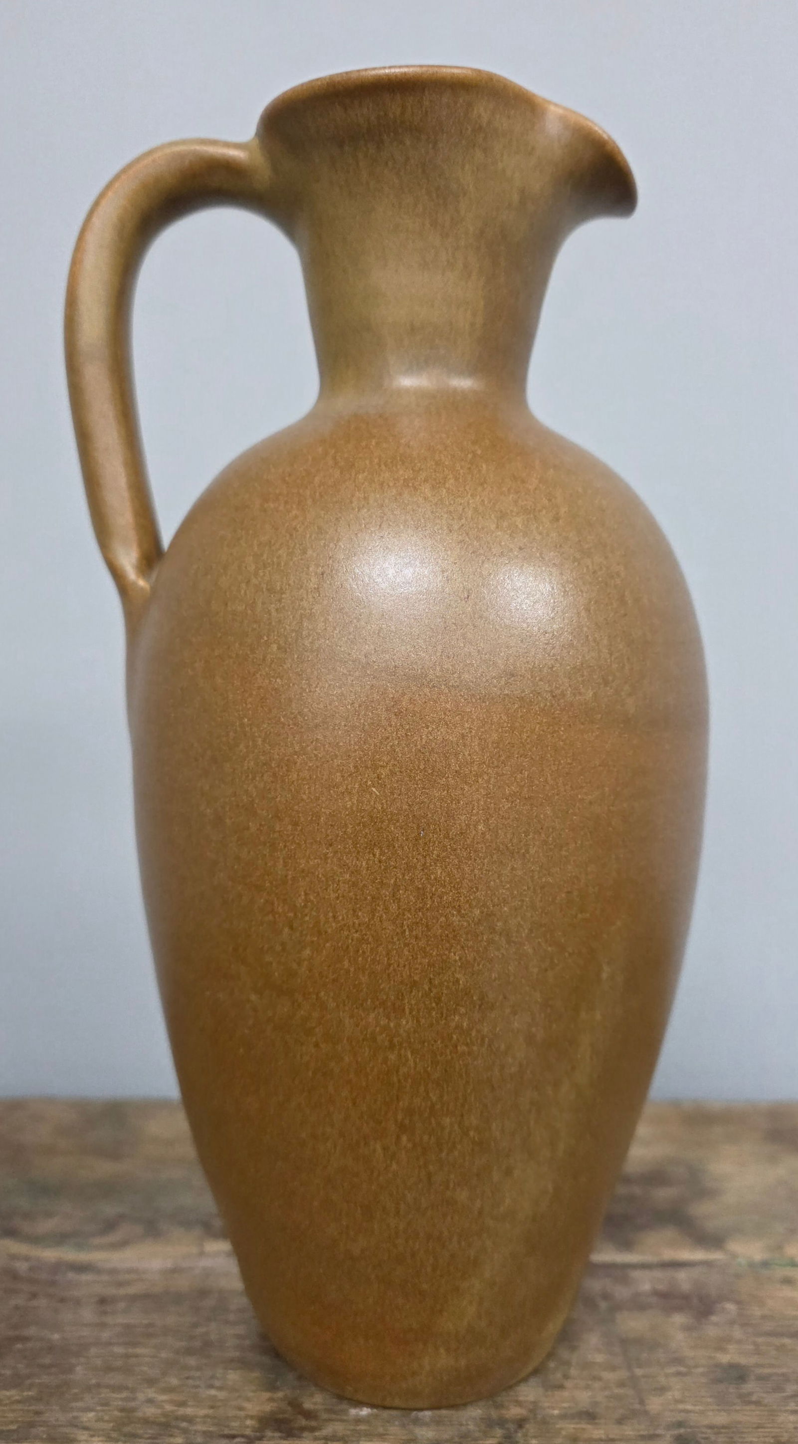 W J Gordy Single-Handle Pitcher: W J Gordy Pitcher. Single-handle with Mountain Gold glaze and signed on the bottom. Standing: Standing 11" tall.