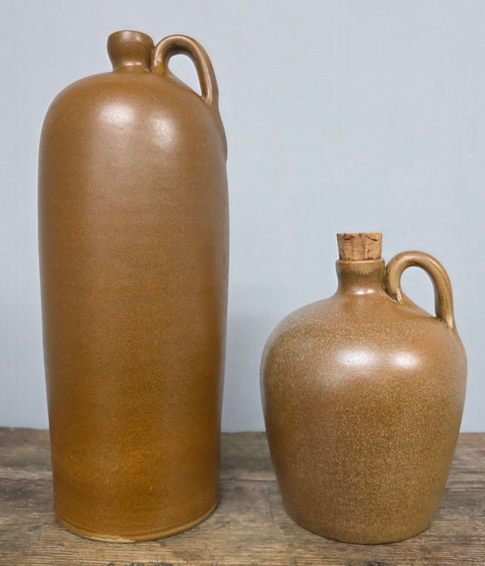 W J Gordy Single-Handle Jugs Lot of 2: W J Gordy Single-Handle Jugs Lot of 2. Both are in Mountain Gold glaze and signed on the bottom. 1-Standing: 6 1/2" signed by Gordy and "Made Especially For Dr. William Klopstock 1965" on the bottom.