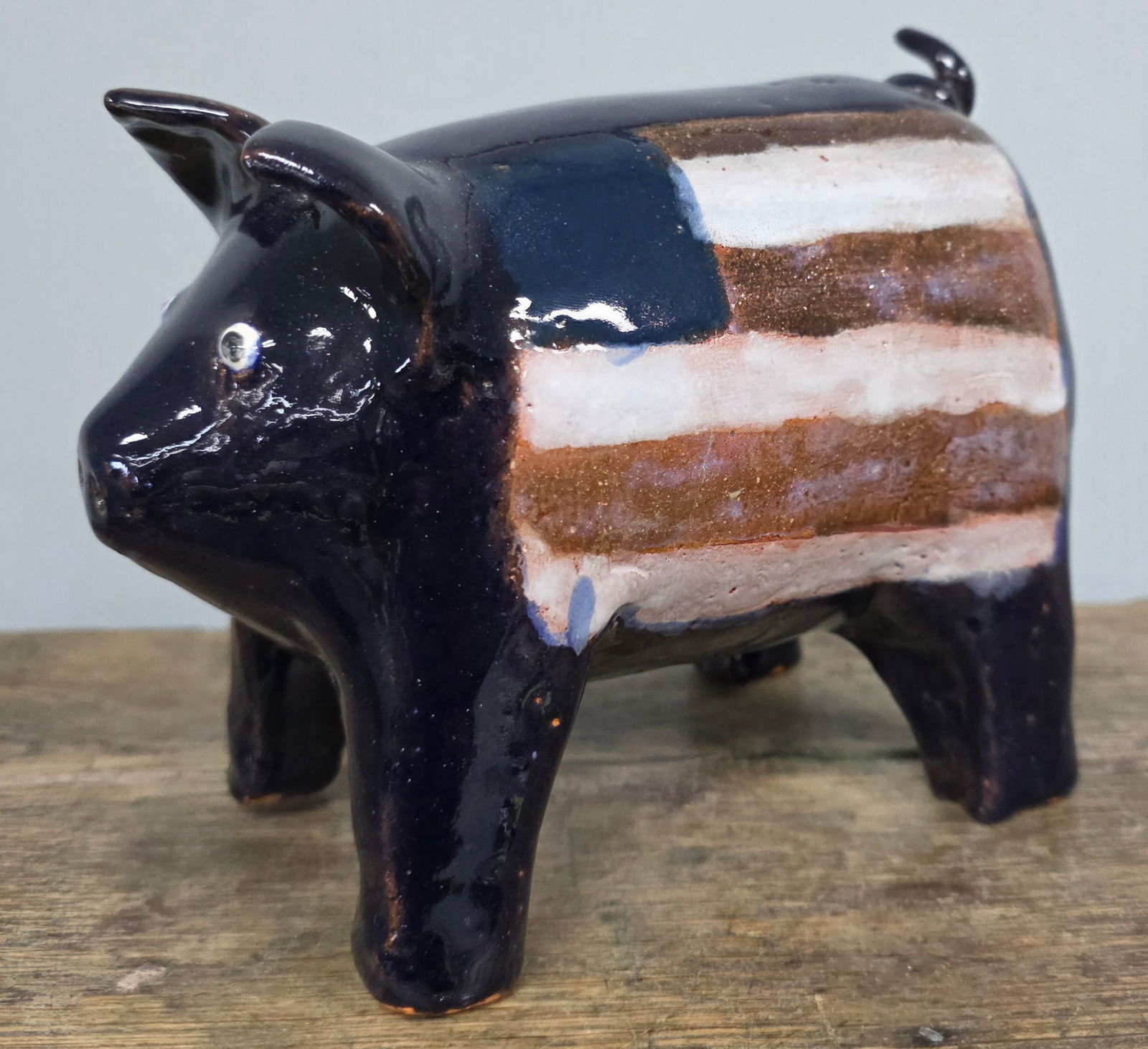 Larry Wilson Folk Pottery Patriotic Pig: Larry Wilson Folk Pottery Patriotic Pig, in collector grade condition with no repairs. Standing 6 3/8" tall x 7 1/2" wide.