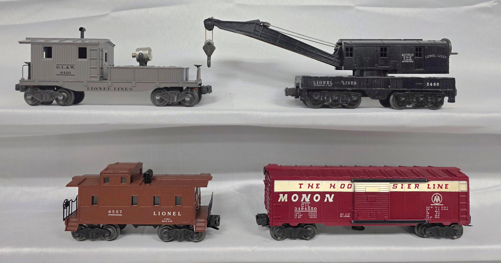 Lionel Postwar Lot of 4: Lionel Postwar Lot of 4. 1-349-4450 (Monon) The Hoosier Line in C-8 condition. 2-2460 Bucyrus Erie in C-7+ condition. 3-6557 Lighted and Smoking Caboose in C-8+ tested and working condition. 4-6420