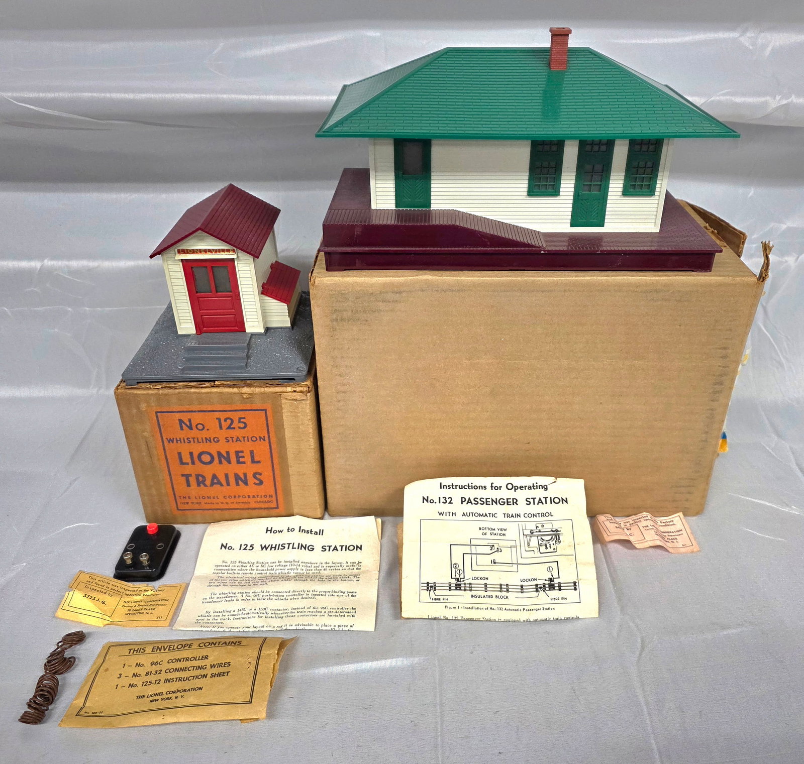 Lionel Postwar 132 & 125 Stations Lot of 2: Lionel Postwar 132 and 125 Stations Lot of 2. 1-132 Illuminated Station in C-10 condition. Included are the original instruction manuel and original inspection tag. 2-125 Whistling Station in the