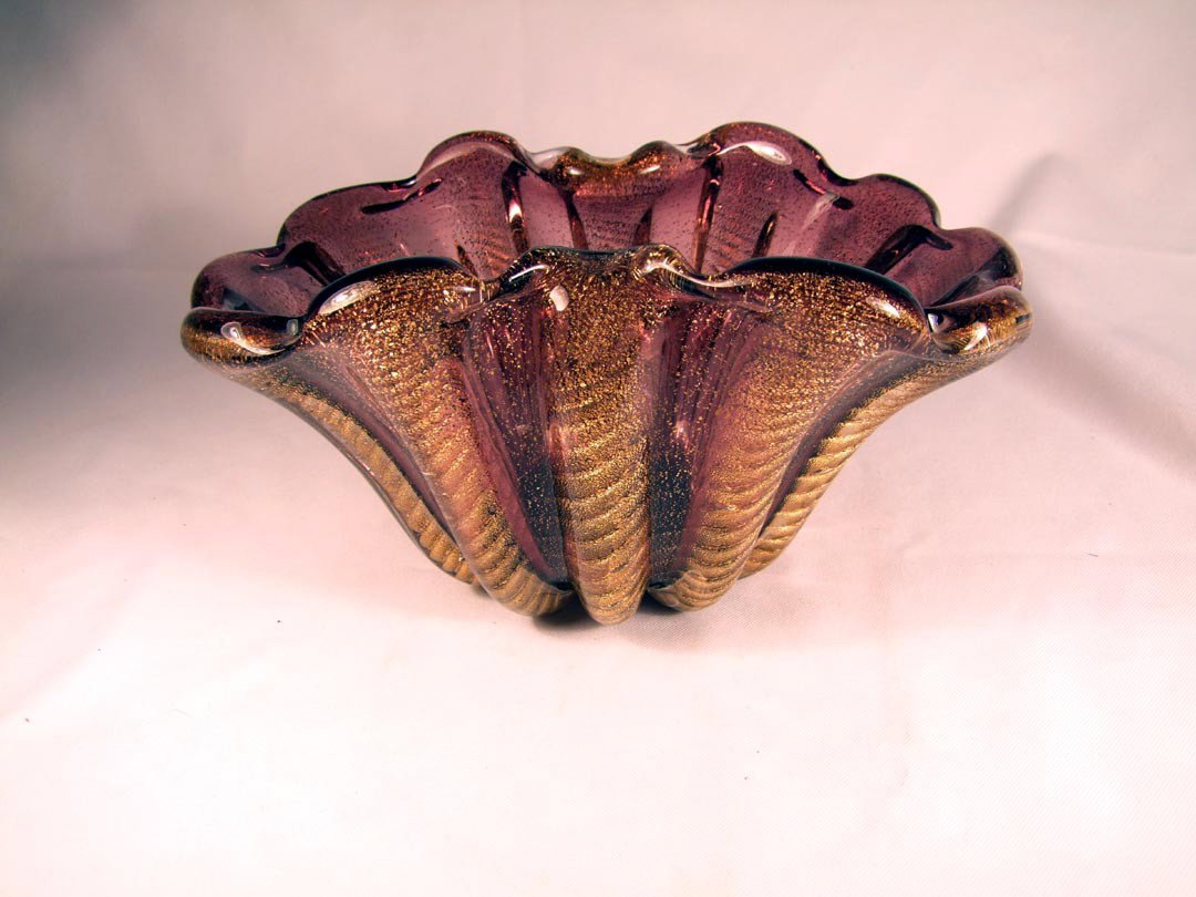Murano Venetian Glass Bowl: Unsigned, attributed to Barovier and Toso, 1950s. Lavender/purple free form glass with fluted columns of gold flecks. 11" x 7" x 5 1/2" high.