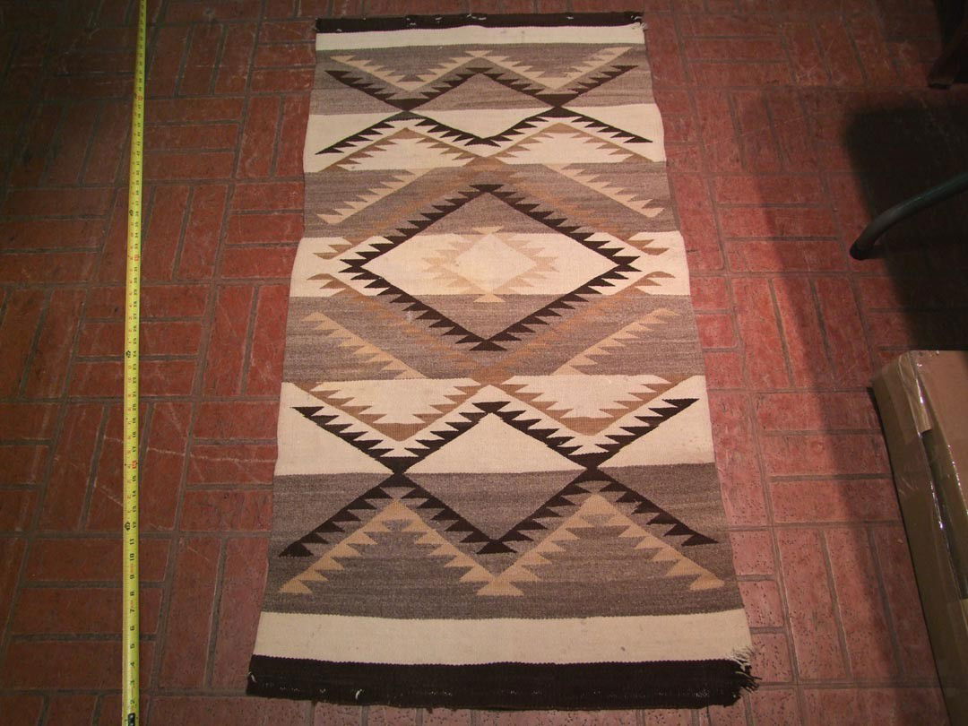 Navajo Rug: 1900 - 1925 hand-made Grey Hills Navajo rug. Wear on both ends, scattered spots. 28" x 54".