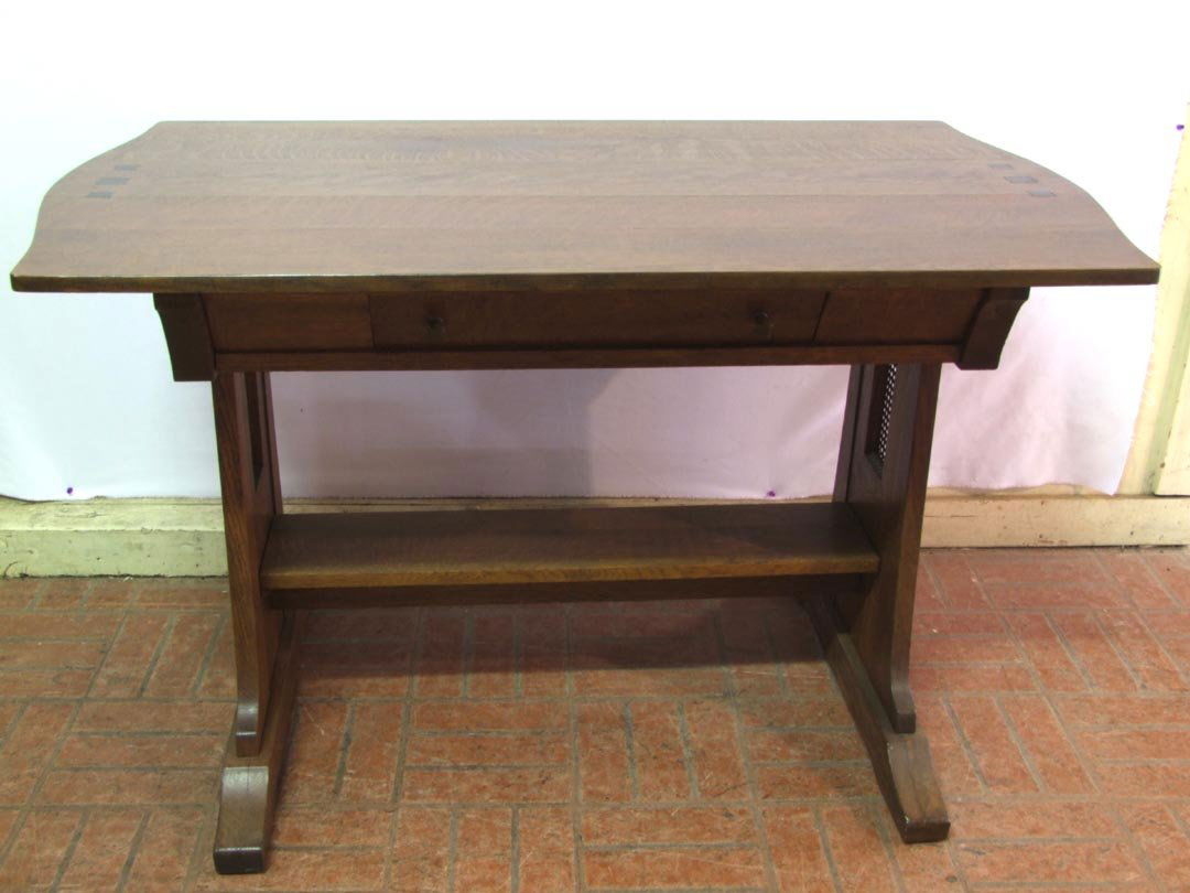 Limbert Arts & Crafts Library Table: Oak table with single drawer, ebony inserts on the top and on the sides. Branded mark inside the drawer. Caned panels on sides. Refinished. 48" x 27 3/4" x 29 1/4" high. Separation on the top, seen in