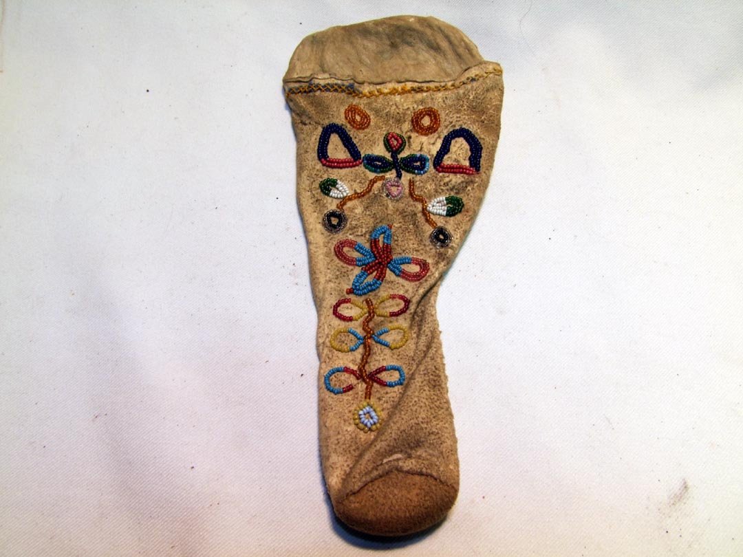 Santee Beaded Holster: 1890s Santee holster with beading on soft pliable doe skin. Colorful beadwork with only two or three beads missing. Cross-stitched top. 4 1/2" x 9".