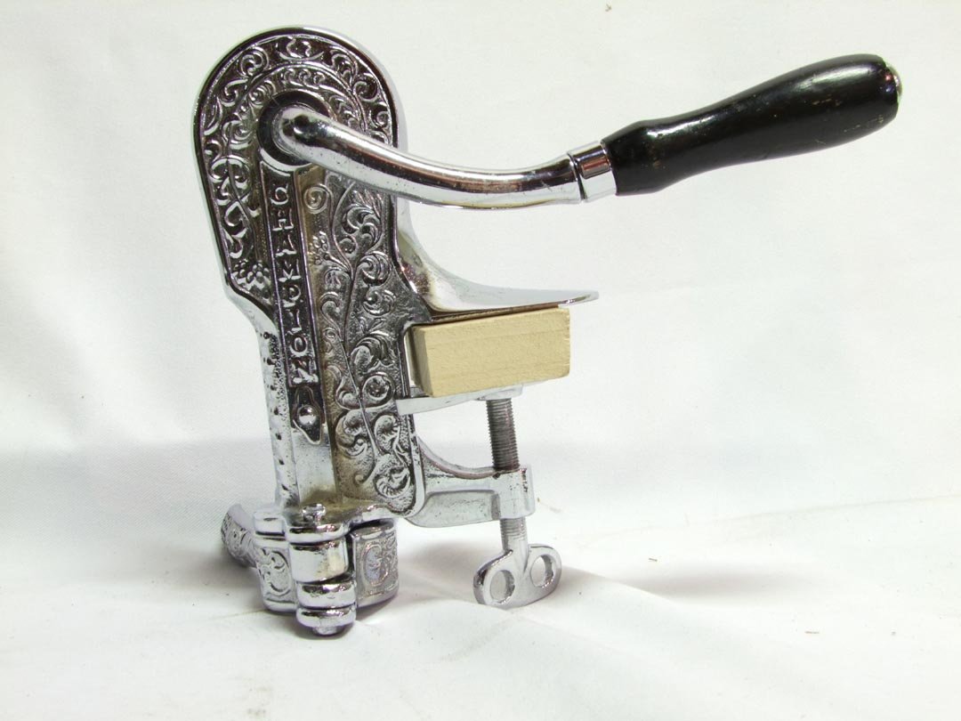 Champion Nickel Plate Bottle Opener: Patent date June 1896, with nickel plating on all of the metal, ebonized wood handle. Counter mount. 8 1/2" high.