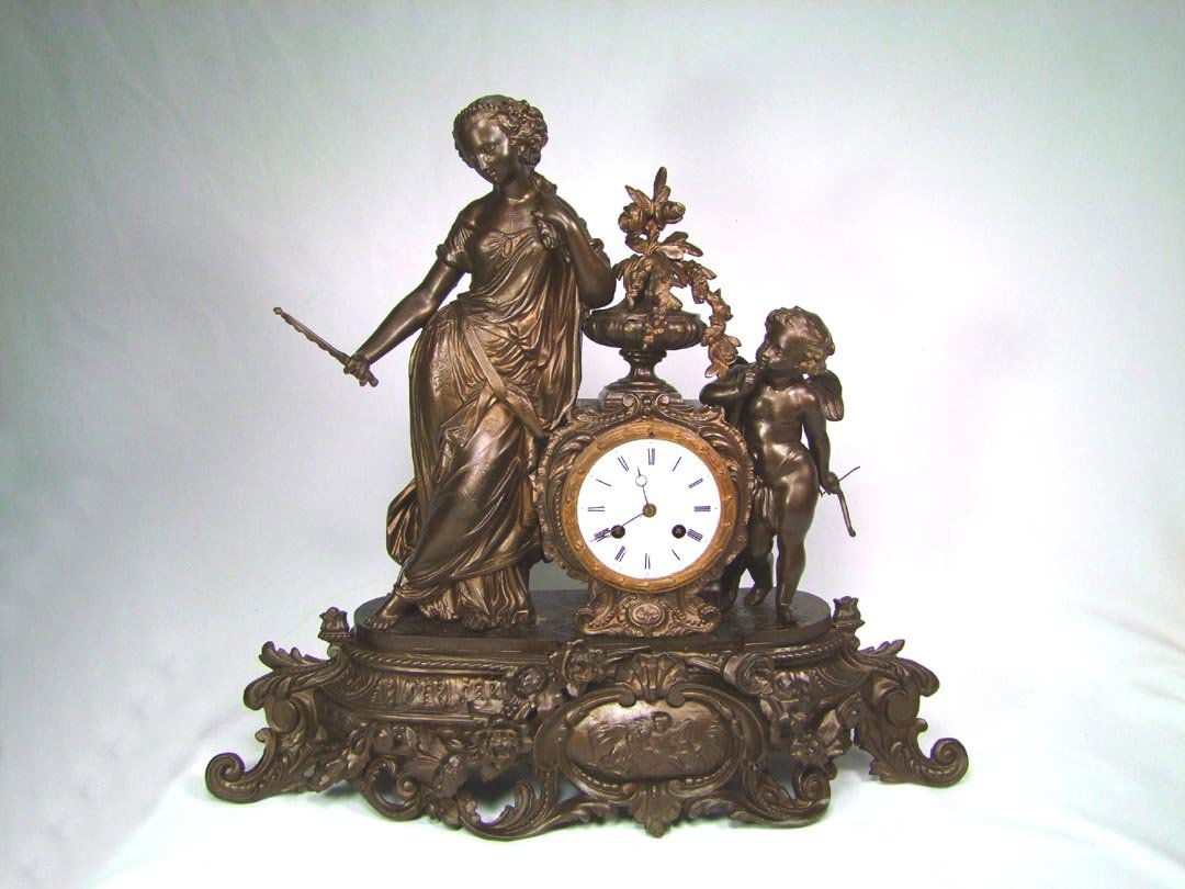 Figural L. Japy Fils Clock: Spelter figure of Aphrodite admiring her own beauty as she looks into the hand mirror. Cupid with his bow stands watching. Porcelain dial with Roman Numerals. Movement marked Medailles D'Argent, L. Ja