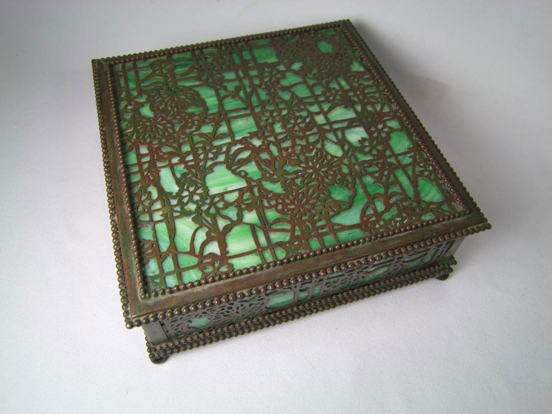 Tiffany Bronze Trellis Filigree Overlay Box: Handkerchief box with hinged lid stamped base Tiffany Studios, New York with the original green slag glass. Trellis metalwork design with vines and flowers that Tiffany referred to as Etched Metal and