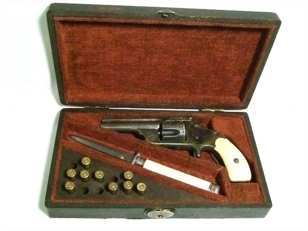 Cased Smith And Wesson 5-Shot Revolver And Knife: Serial number 96028 revolver with 3 1/4" round barrel and ivory or bone grips. Stamped on the barrel, Smith & Wesson Springfield Mass. U.S.A., with last pat'd date May 11, 1880. Key locking case also
