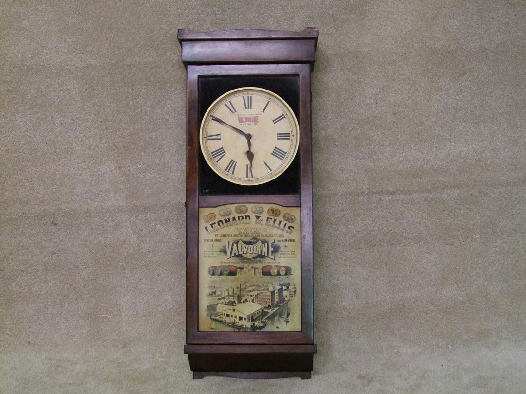 Valvoline Advertising Clock: New Haven wall clock advertising Valvoline Motor Oil. Painted dial and tin panel on the lower section of door. 17" x 42" high. Works.