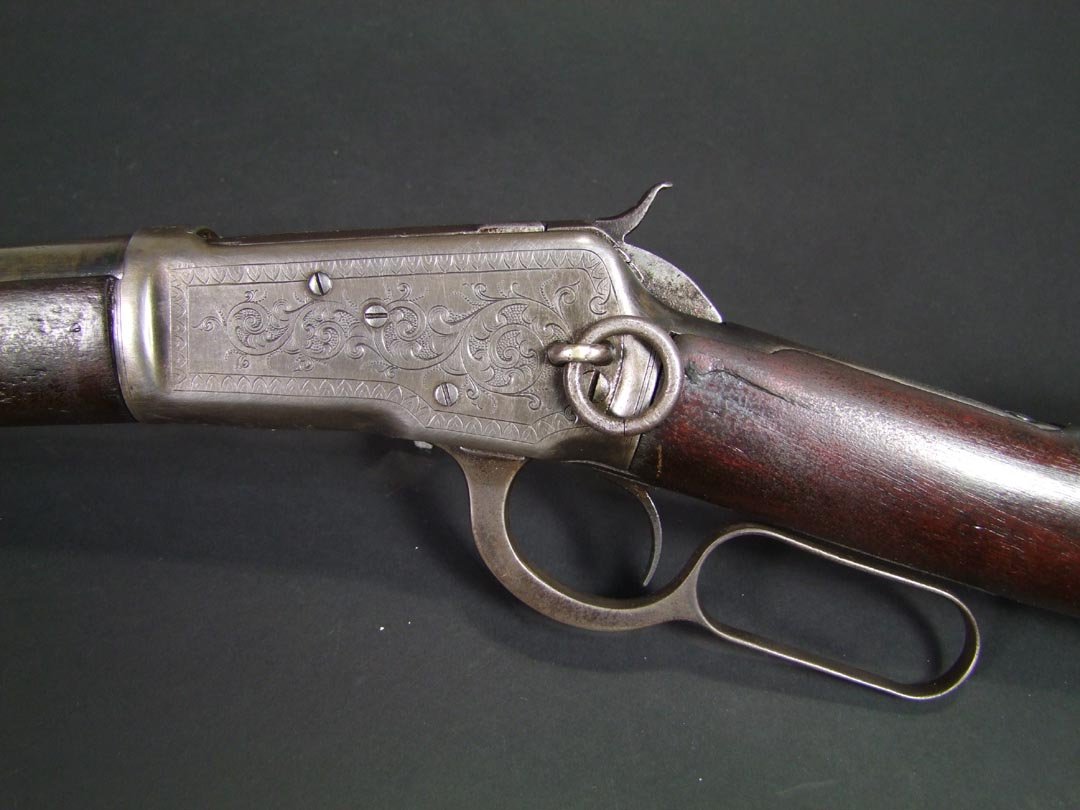 Winchester 1892 Carbine: Engraved Lever Action Winchester Model 1892 Saddle Ring Carbine. Top of the barrel is marked, "Manufactured By The Winchester Repeating Arms Co., New Haven Conn, U.S.A. Patented October 14. 1884." mar