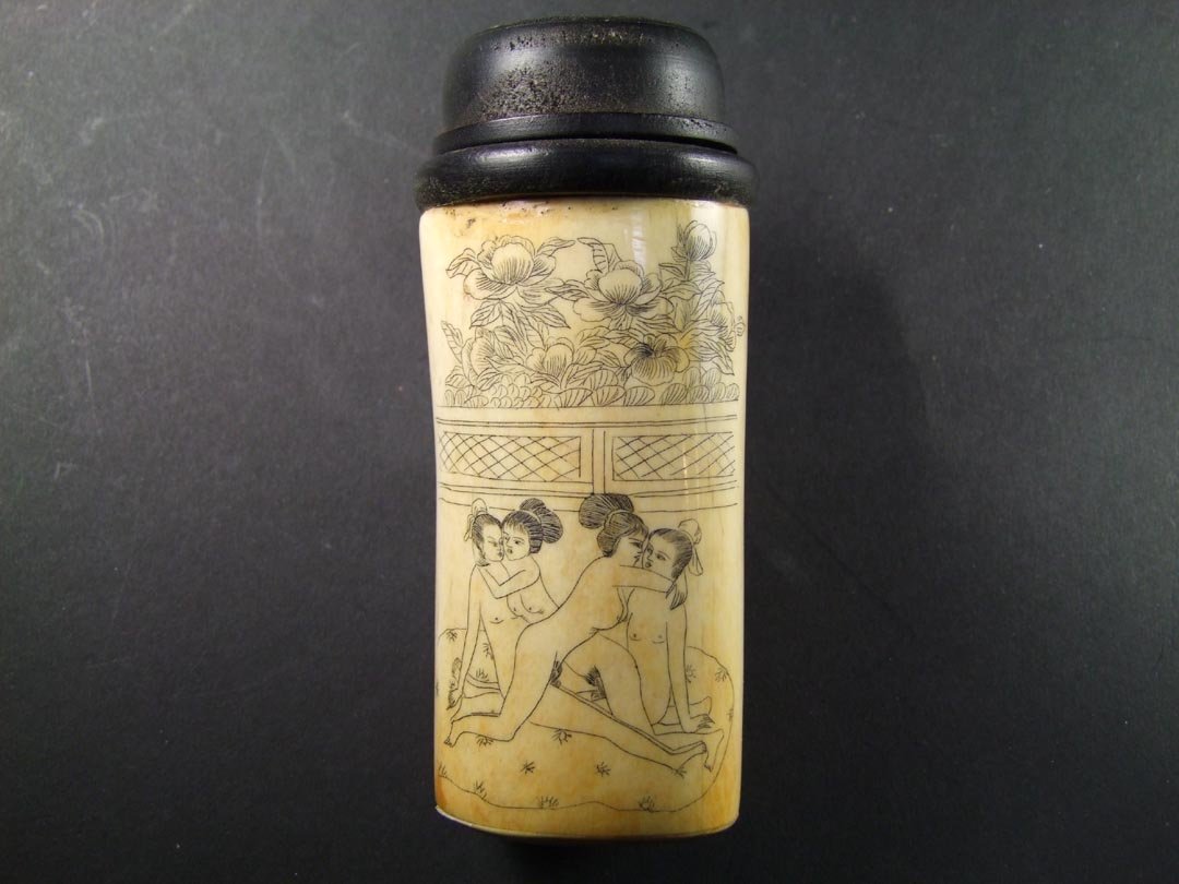 Erotic Cricket Box: Scrimshaw bone cricket box with erotic scenes on both sides. Pierced bone and wood lid. 5 1/2" high. 20th century.