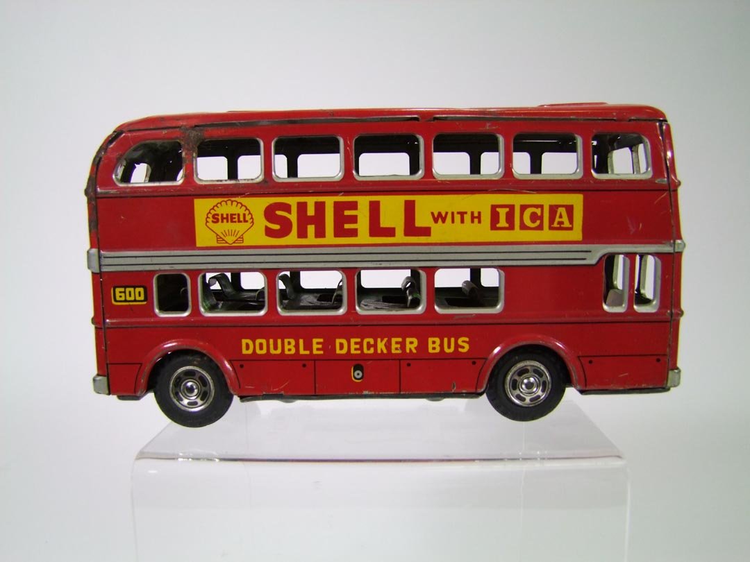 Hayashi Toy Bus: Japanese double decker bus advertising Mobilgas on one side and Shell on the other. Friction toy with hard rubber tires Hayashi Trade Mark. 8 1/4" x 2 1/2" x 4 1/4" high. A few scuffs with surface rus