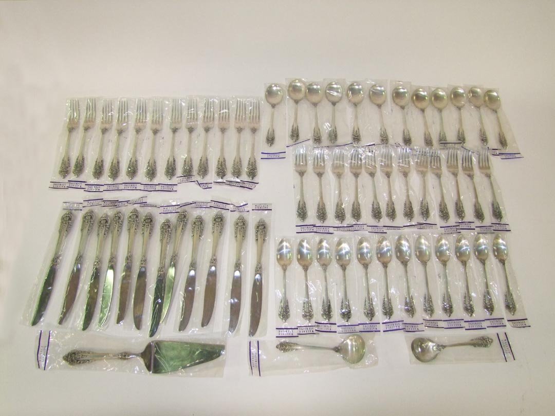 63 Pc Wallace Grand Baroque: Unused and still in original unopened plastic twelve sterling 5 piece place settings of Wallace's Grand Baroque flatware. Set consists of twelve each: 9" knives with SS blades, 7 1/2" forks, 6 1/2" sa