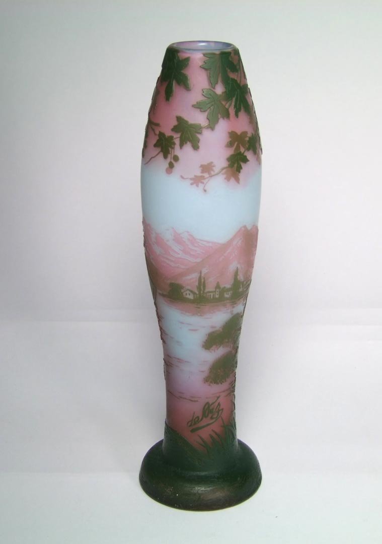 DeVez Cameo Vase: Three color cameo vase with pale blue, pink and green showing a lake scene with a sail boat and a village against mountains in the background. Signed DeVez in cameo. 2 3/4" base x 9 3/4" high. No chip