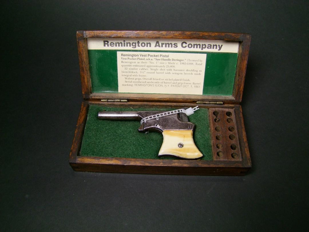Remington Vest Pocket Pistol: 1865 - 1888 22 cal. Remington gambler's pistol only 4 1/4" long to fit into a vest pocket. Very nice Ivory grips. Top of barrel reads "Remington Ilion NY,Patent Oct. 1 1861". Serial number 1554. Very 