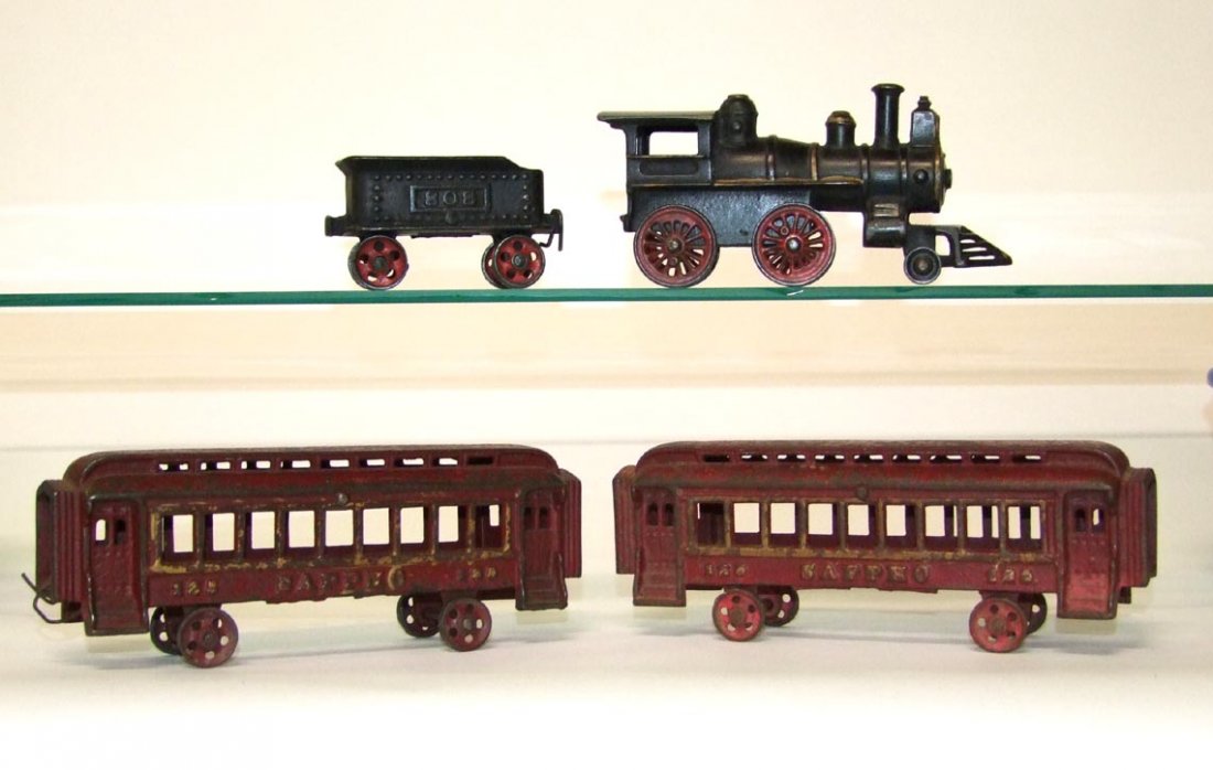 Vintage Iron Train Set: Pictured in the book CAST IRON FLOOR TRAINS with the 7 3/16" locomotive, 4 1/4" 808 tender and two 9 1/4" coaches 125 Sappho. No cracks, breaks nor repairs.