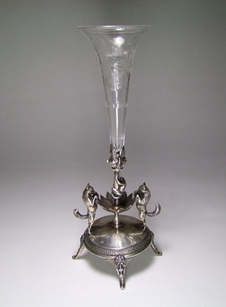 Silver Plate Holder And Vase: Reed and Barton 2640 silver plate holder showing two dogs and have cornered a monkey. Floral engraved clear glass slip vase fits securely into the holder. 1890s. 11" assembled height. Interior scratch