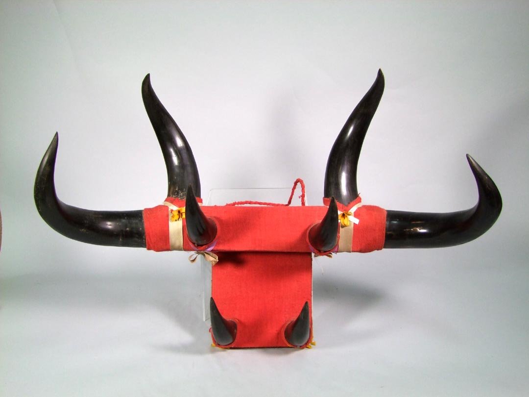 Steer Horn Hat Rack: Hat and coat hanger made of 8 steer horns with faded red felt and ribbons. 27" x 18" high. Good condition.