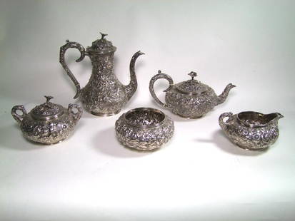 Kirk Repousse Sterling Set: Sterling tea and coffee service by S. Kirk & Son Co. in Repousse pattern. The mark was used between 1896 - 1924. Set consists of: 10" high coffee pot weighing 37.21 ozt., 5 1.2" high tea pot weighing