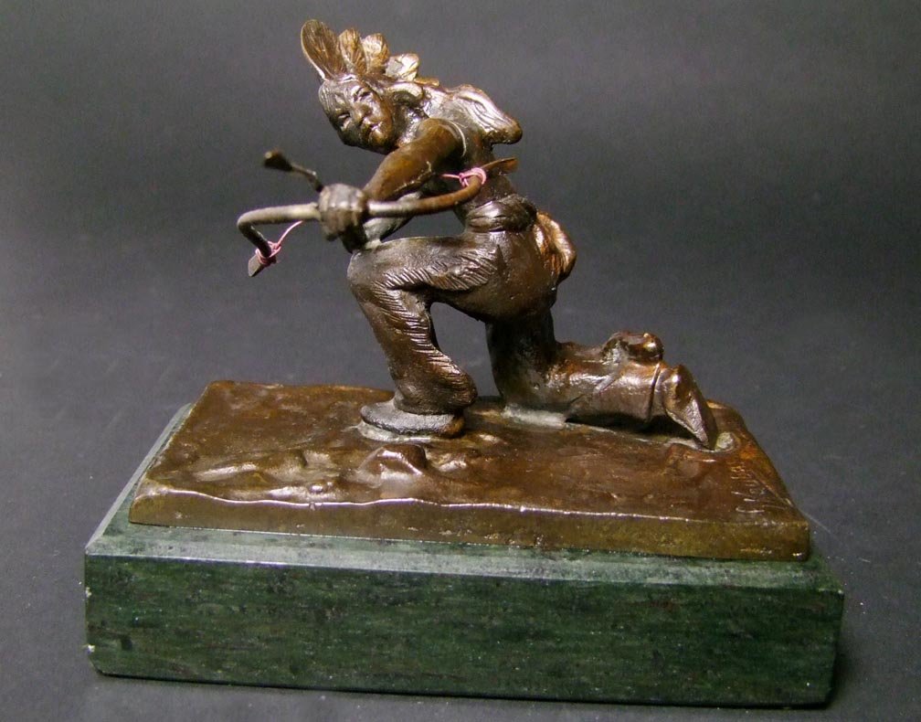 Carl Kauba Indian: Signed in the bronze C. Kauba for Carl Kauba, Austrian sculptor (1865 - 1922) showing an Indian down on one knee with his bow pulled back ready to shoot. Mounted on marble base. 4 1/2" x 2 7/8" x 4" h