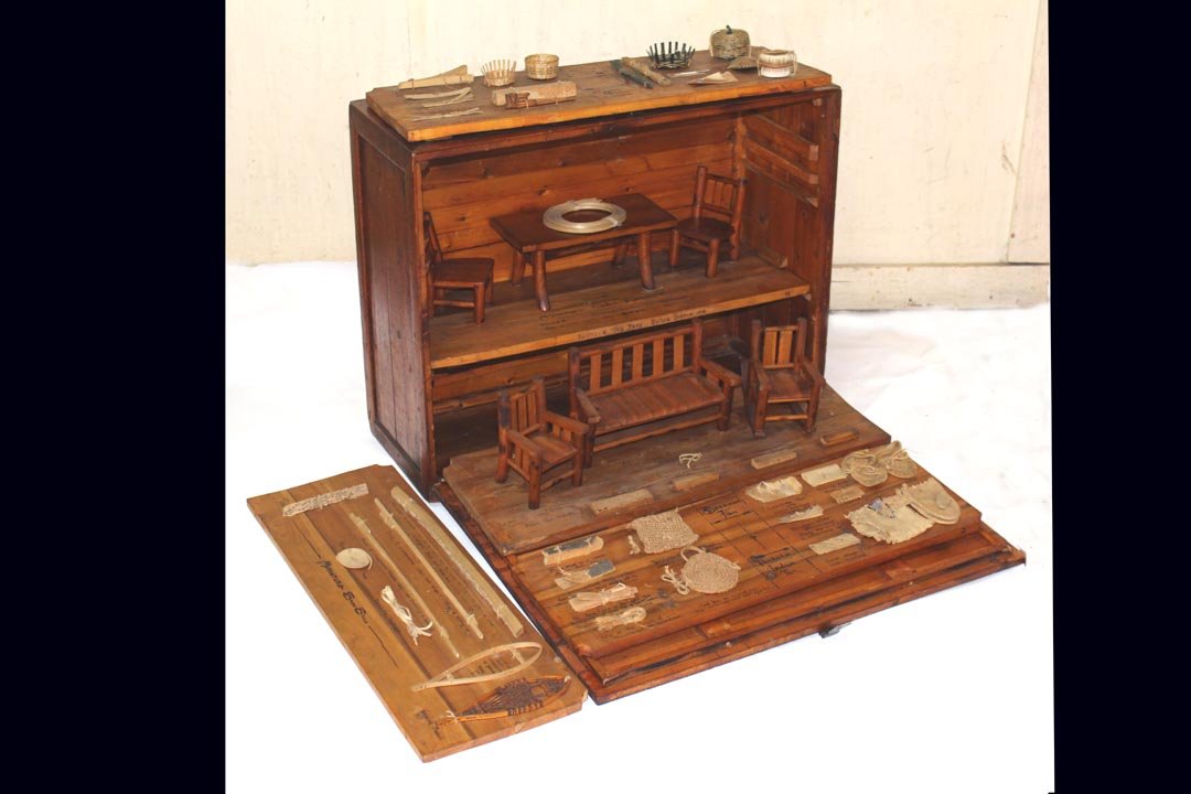 1900s Trading Post Display: Incredible hand made display in miniature of available goods from area tribes around Mackinac, Michigan. Five removable shelves showing basketry, clothing, pipes, snow shoes, moccasins, and furniture.