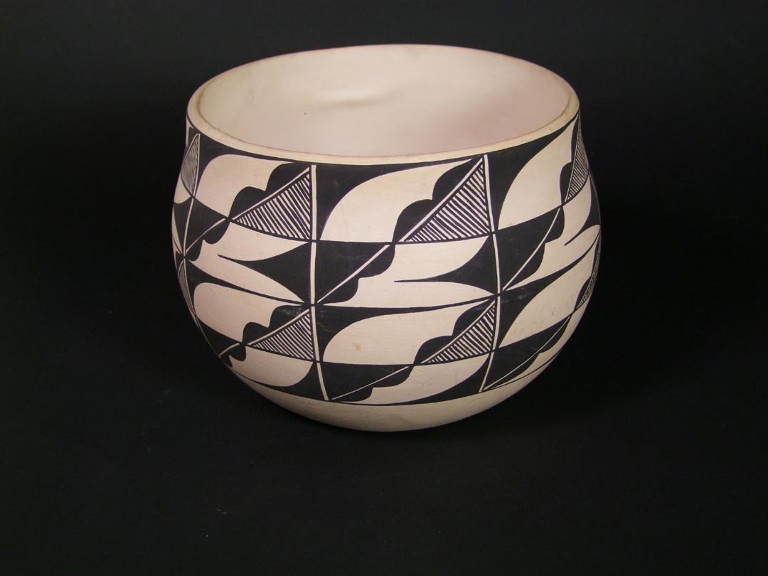 Acoma Pottery Bowl: 1940s Acoma pot with geometric fine line design. The white has aged to a soft cream tone. Artist mark on the bottom, B.D.,Acoma. 7 1/2" diameter x 5 1/2" high.