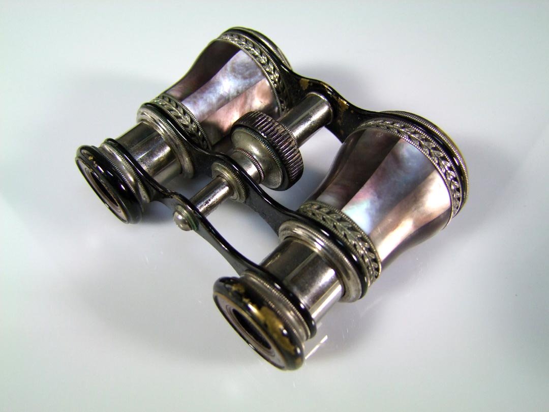French Opera Glasses: LeMaire Fabt Paris opera glass with purple mother-of-pearl on both barrels and eyepieces. Painted black frame showing some loss to the paint. Marked on the eyepieces "LeMaire Ft - Paris" with the LeMa