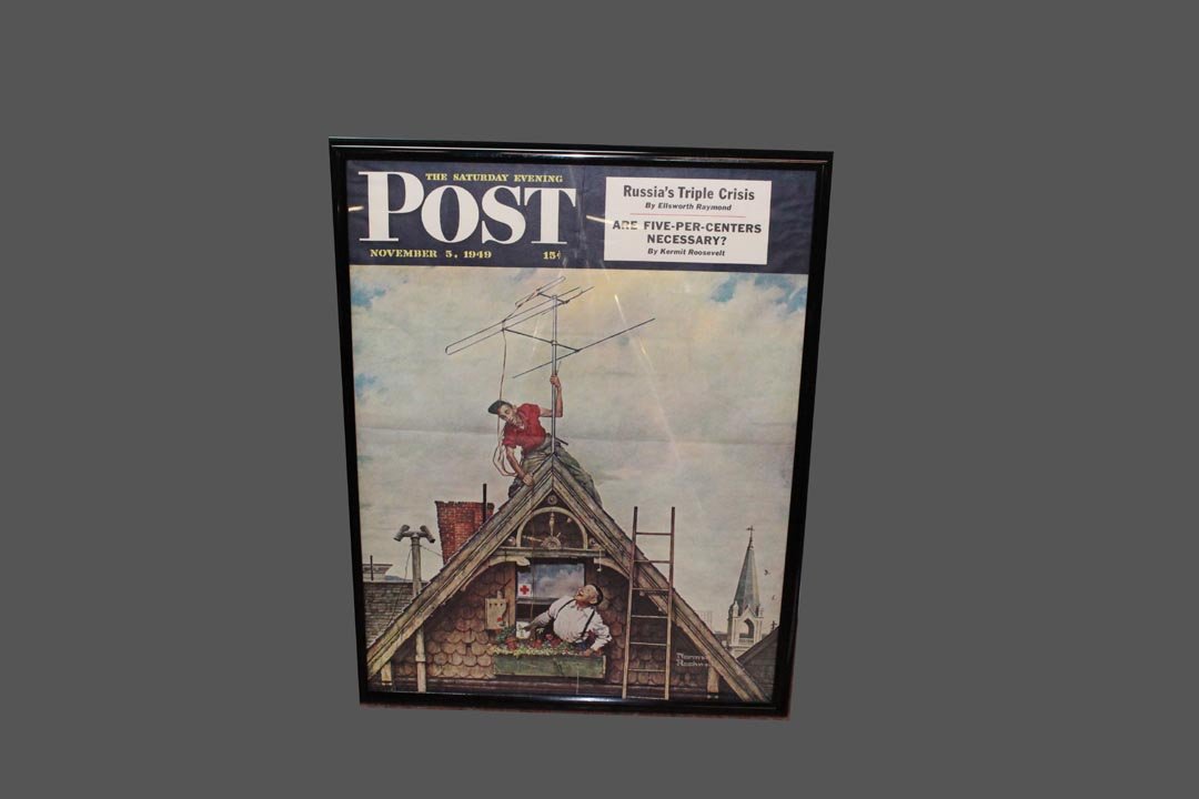 Post Magazine Poster: Original poster by Norman Rockwell, signed in the plate, saluting the beginning of television in America, Nov. 1949. 22" x 28" in very good condition with original fold. Professional repair of two mar