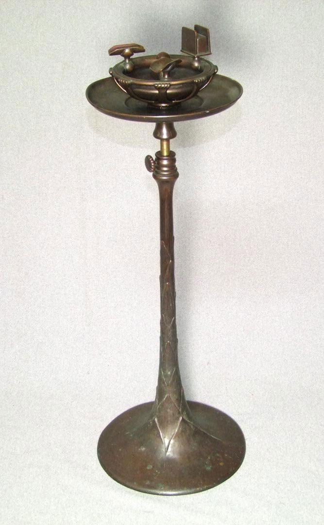 Tiffany Bronze Smoker's Stand: "Tiffany Studios, New York, 1651". Bronze smokers stand with removable clamshell top for dumping and cleaning. 10" diameter base with telescoping stem from 25" up to 37" high. As found uncleaned condi