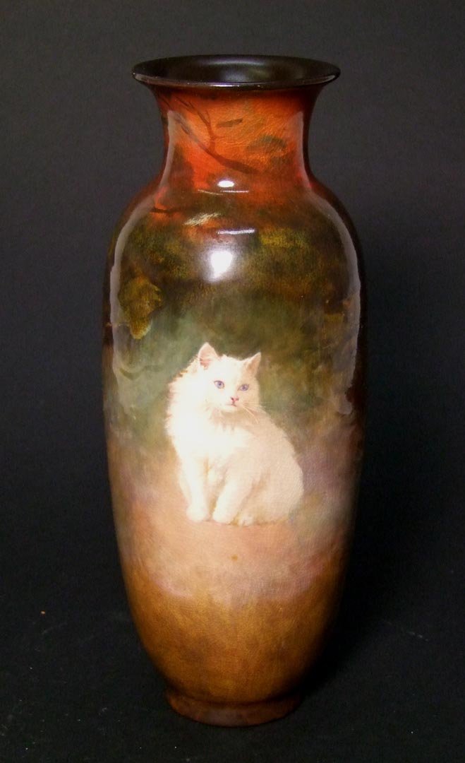 Artist Signed Royal Doulton Vase: Blue eyed fluffy white cat sits proudly on the front of the vase with the artist signature to the right, S. Ternybough. 8 1/2" high. Very good condition.