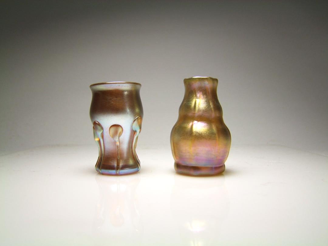 Two Gold Tiffany Miniature Vases: 2" gold vase with applied tadpoles around the body signed D2414, possibly Loetz. 2 1/4" gold gourd shape ribbed vase signed L.C.T. Favrile 2416B. Both in very good condition.