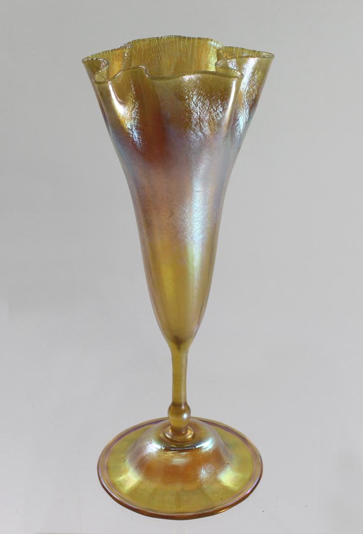 Tiffany Flower Form Vase: 10 1/2" high gold Tiffany vase with irregular onion skin top down to slender stem on a ribbed inverted saucer base with rolled edge signed L.C.T. W7890. Very good condition with no chips, cracks or re