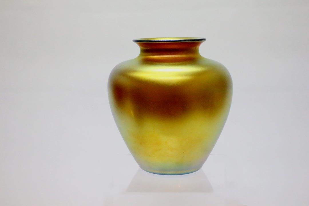 Gold Steuben 2683 Vase: Bright gold Steuben vase shape number 2683 measuring 7 1/2" diameter x 8" high. Incorrect signature but still Steuben. Light surface abrasions on one side. No chips, cracks, chips or repairs.