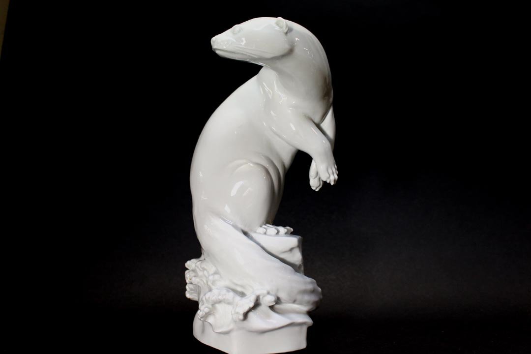 Meissen Modernist Blanc de Chine Otter: Standing otter signed M. Esser with the crossed swords mark under the glaze mold number 78715. 5" x 4" x 9 1/2" high. Very good condition with no issues.
