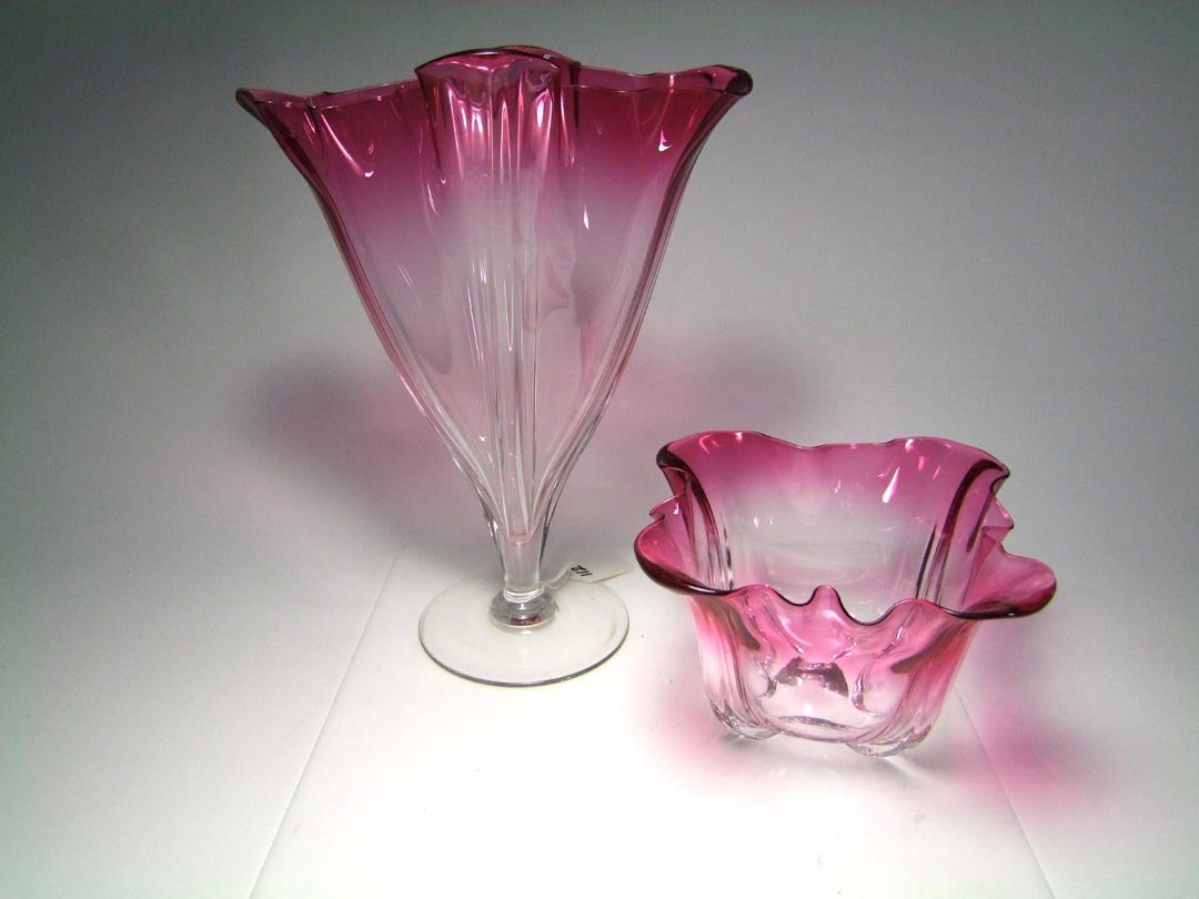 Two Pieces Steuben Cranberry Grotesque: Steuben Grotesque pattern vase with cranberry down to clear 9" x 5 3/4" x 11 1/4" high and companion bowl measuring 8" x 8" x 4 1/4" high. Both pieces in very good condition and unsigned.