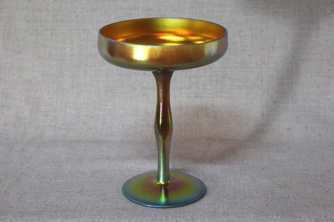 Gold Steuben Compote: Shape number 2642 gold Steuben compote signed Aurene. 6" diameter top, 4" diameter base x 8" high. Green and raspberry highlights. 1/4" light scratch at the outside top otherwise very good condition.