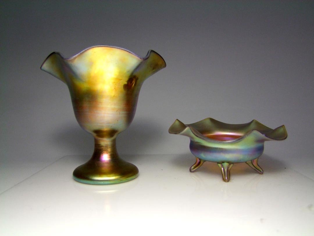 Two Pieces Gold Steuben: Hollow gold ruffle top vase 5 1/2" diameter top x 5" high with mirror finish inside and out signed aurene 217 and gold ruffled bowl with four applied feet 5" in diameter x 2 1/4" high. Both pieces in 