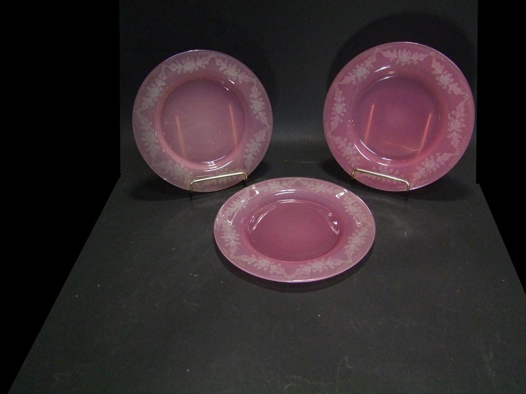 Steuben Rosaline Plates: Three intaglio cut Steuben Rosaline plates decorated with floral sways on the border 8 3/4" diameter. Unsigned and in very good condition.