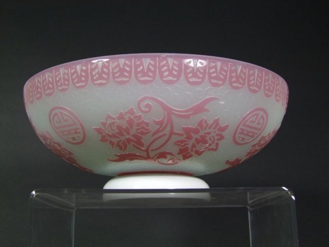 Steuben Acid-Cut-Back Bowl: Roseline on alabaster with Fredrick Carter's signature medallion and flowers on the exterior. The raised foot has an impact crack on the rim but not unstable. 10" diameter x 4" high.