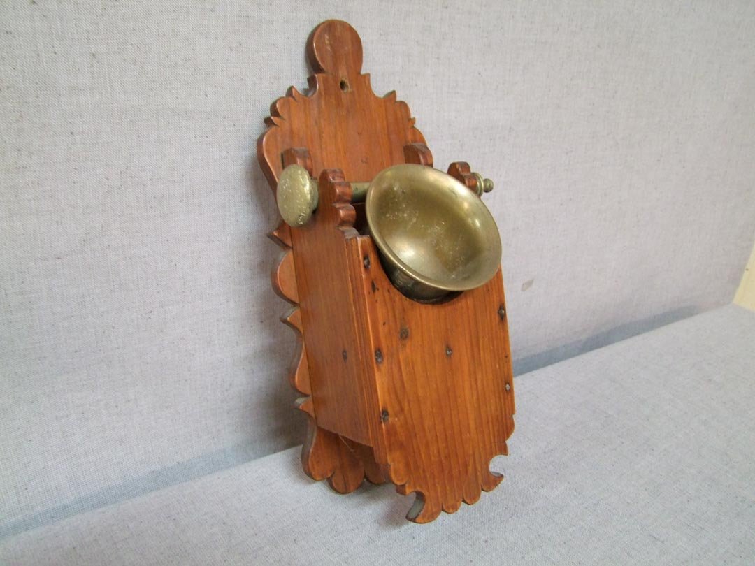19th Century Mortar And Pestle: Scandinavian brass mortar and pestle with a white pine wall caddy. Holder measures 6 1/2" x 15 3/4" high. No Maker's Mark. Mid to late 19th century.