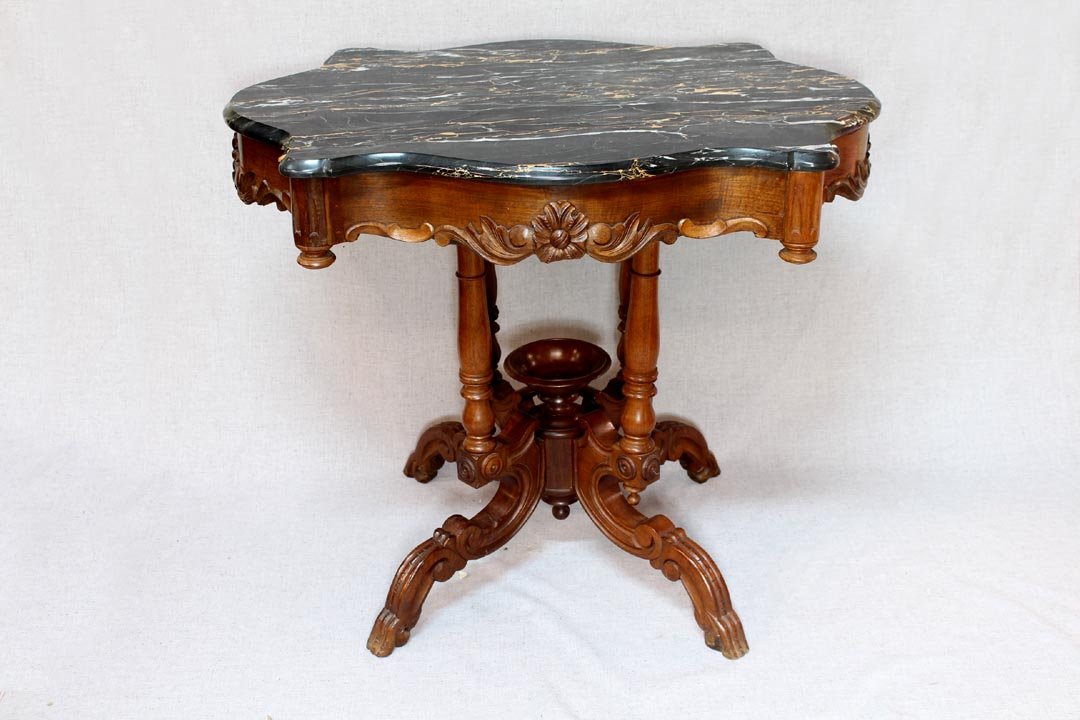 Victorian Turtle Top Parlor Table: Walnut Victorian table with gold veined black marble top. Four turned upright supports each over a sprawled leg jointed at the center with a carved wood bowl. 34 1/2" x 25 1/2" x 29" high. 1860s. Refi