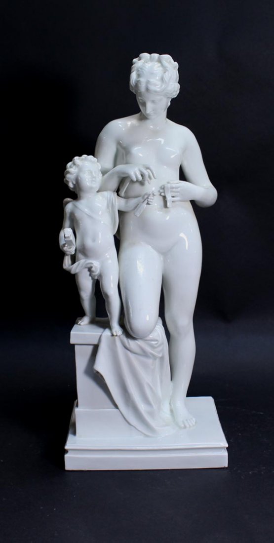Meissen Venus And Cupid Group: 1890s blanc de chine figure of Venus standing with one knee resting on a pedestal that cupid is standing on. The arrow in cupid's hand is missing the end. L 156 incised next to the Meissen Mark. 6 1/4