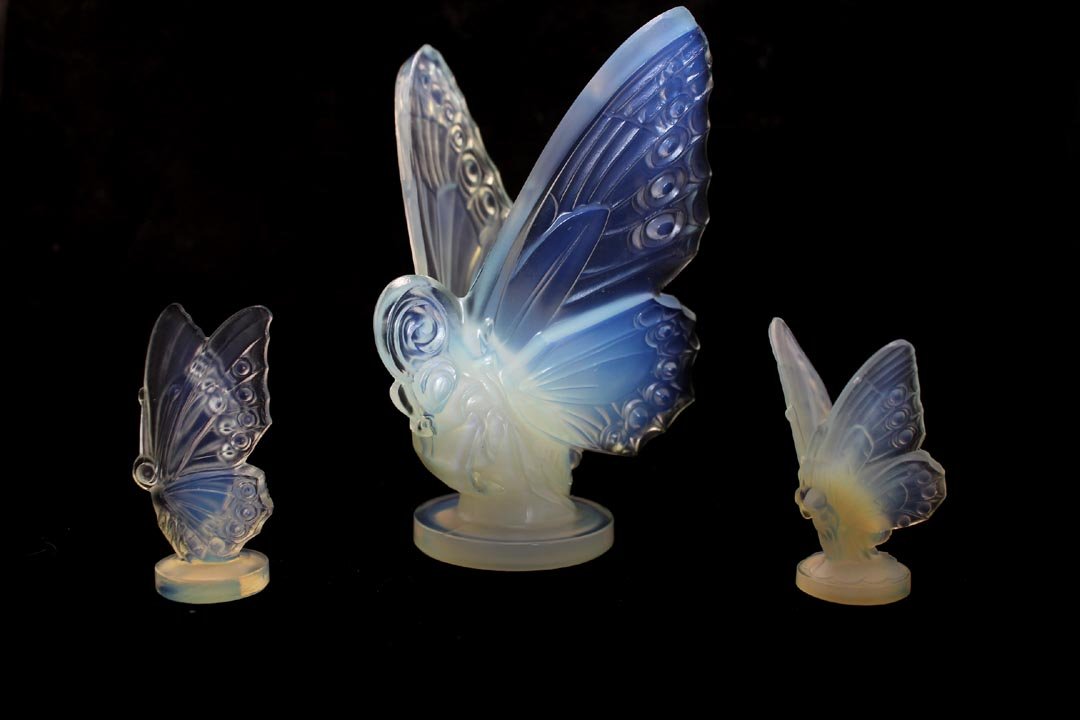 Three Sabino Butterflies: 6" high open wing butterfly signed in raised block letters on the wing and in script on the bottom. One smaller open wing and one closed wing butterflies with paper labels. All in very good condition.