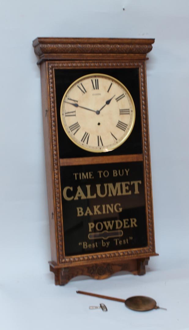 Calumet Baking Power Advertising Clock: Sessions oak case wall clock advertising Calumet Backing Powder. 16 1/2" x 37" high. Works.