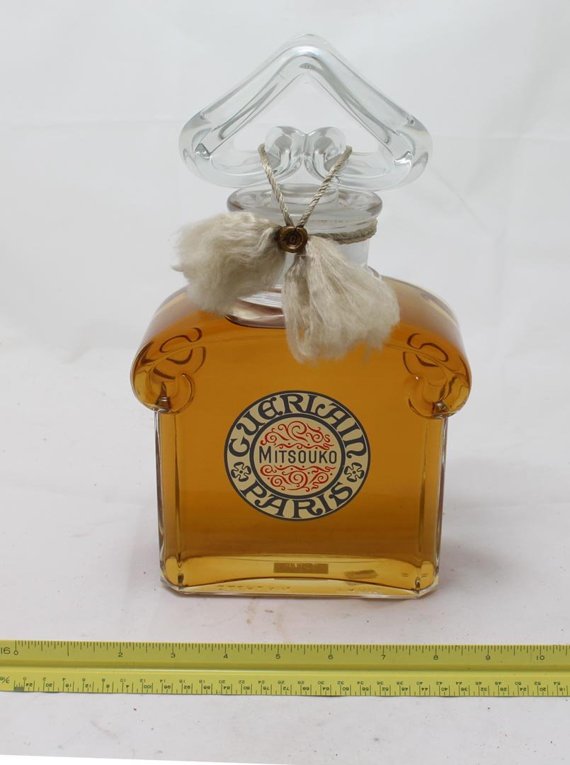 Guerlain Mitsouko Factice: 11 3/4" bottle with contents. Bottom of bottle marked with raised letters, Guerlain Paris. Paper tag marked Factice, Vente Interdite, Dummy, Not For Sale. Very good condition.