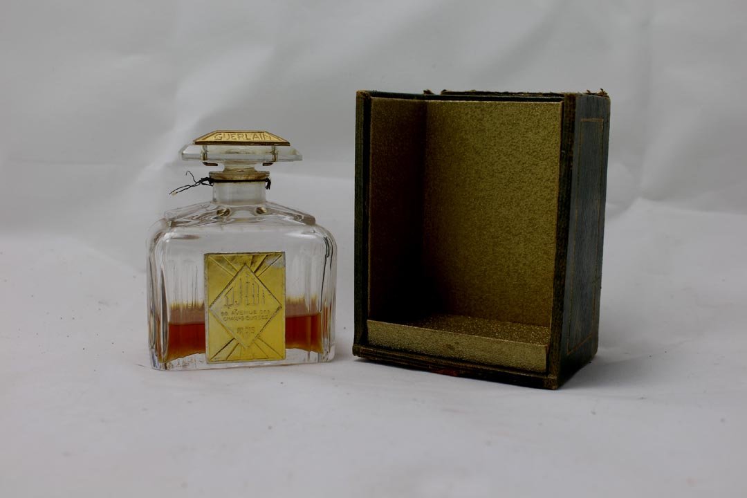 Guerlain DJEDI Bottle: Box is incomplete. Bottle made by Baccarat from the 1920s with original stamps on the bottom. Bottle has wear. Box measures 3" x 2" x 4".