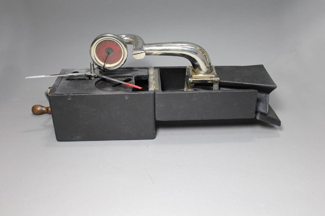 Peter Pan Traveling Gramophone: The folding speaker is spring loaded and extends automatically. The arm and producer slide onto the speaker. The folding turn table and crank as well as the other parts all snuggly fit into the small 