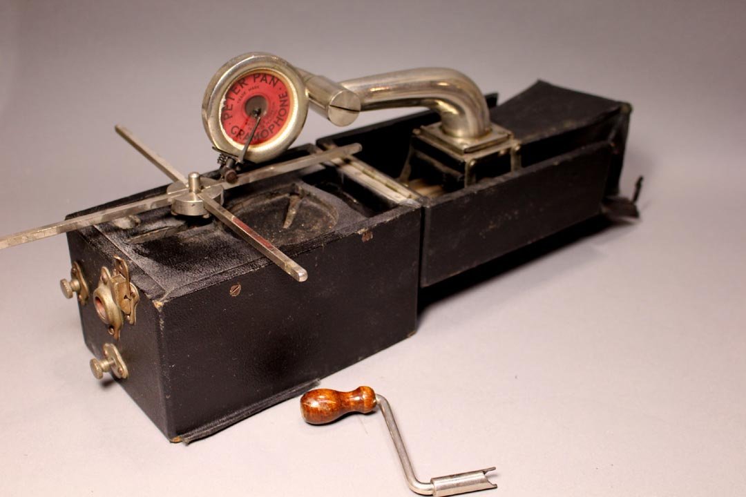 Peter Pan Traveling Gramophone: The folding speaker is spring loaded and extends automatically. The arm and producer slide onto the speaker. The folding turn table and crank as well as the other parts all snuggly fit into the small 